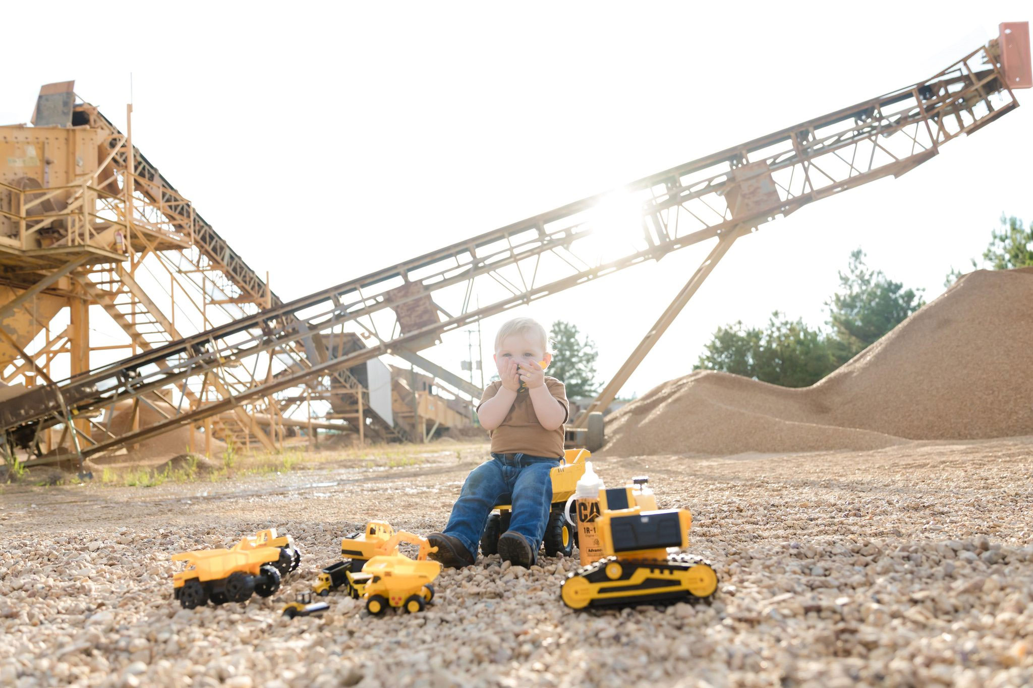 A child plays with toy trucks at the Magnolia Sand & Gravel aggregate yard in Summit, Mississippi